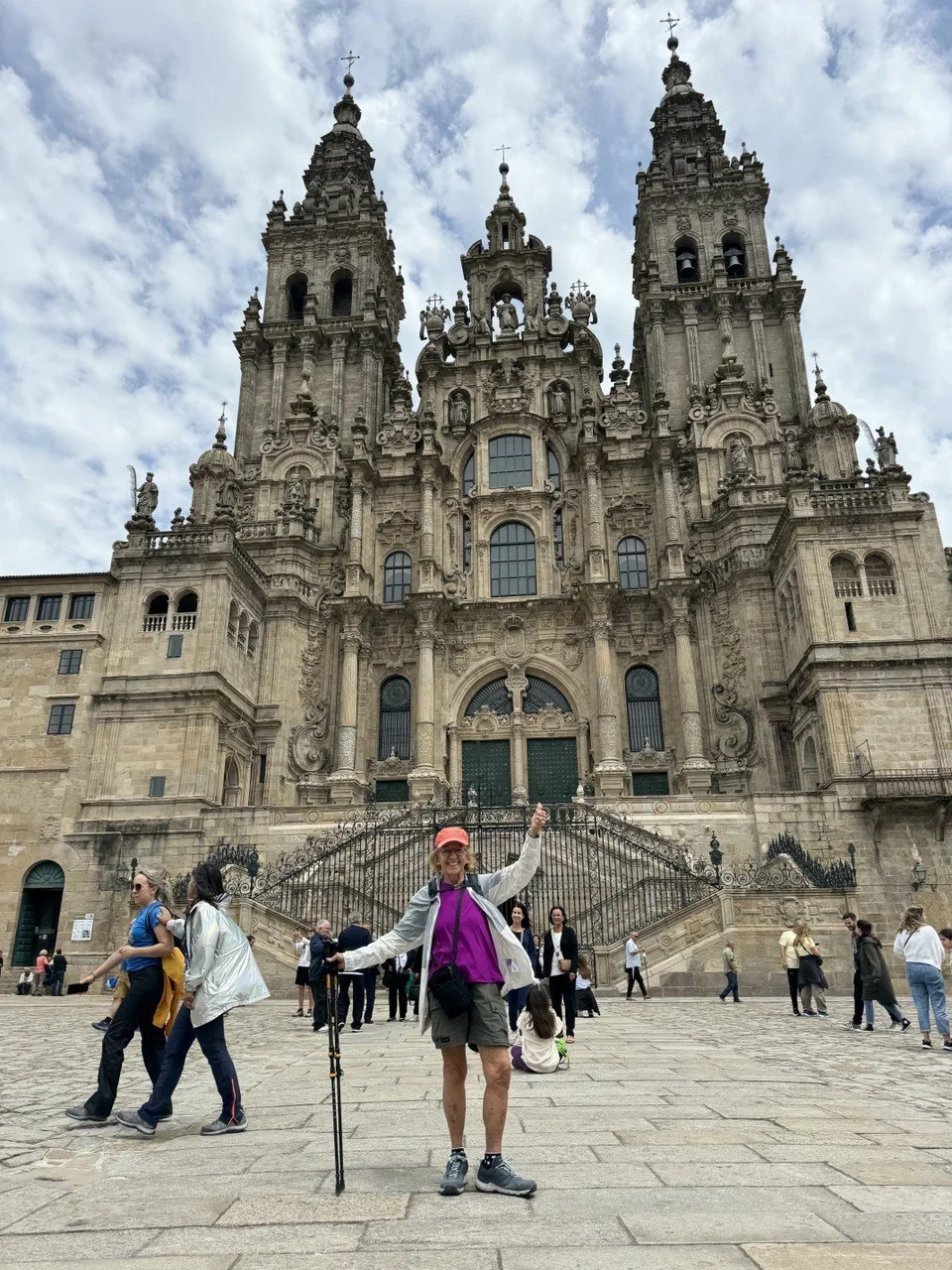 Diana celebrating in front of the Santiago de Compostela cathedral at the end of her El Camino walk